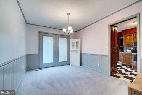 a view of a room with window and chandelier