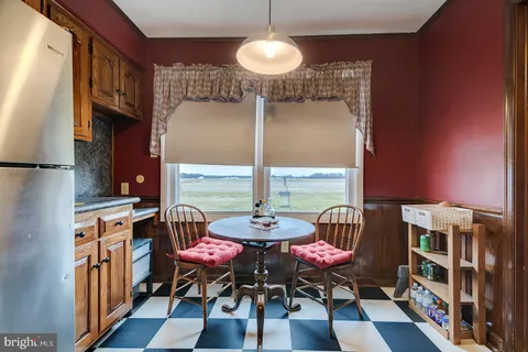 a dining room with furniture and wooden floor