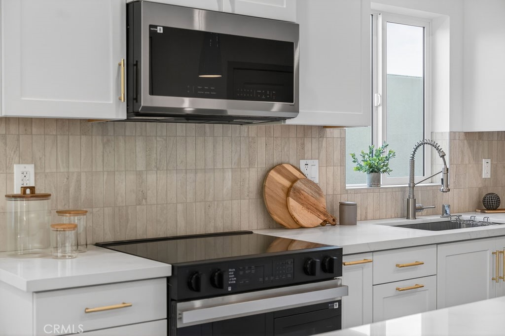 15540 Colorado Avenue Paramount, CA 90723 - Photo 14 of 63 a kitchen with a stove and a microwave