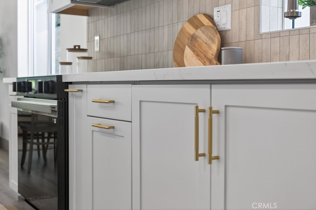 15540 Colorado Avenue Paramount, CA 90723 - Photo 17 of 63 a kitchen with a refrigerator and cabinets