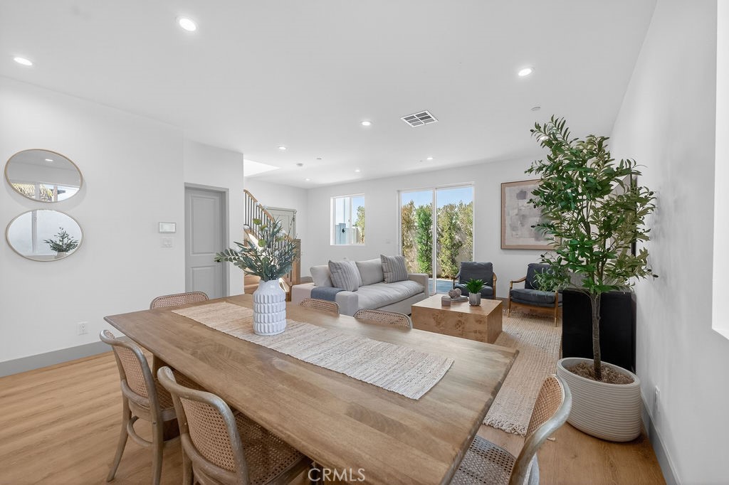 15540 Colorado Avenue Paramount, CA 90723 - Photo 20 of 63 a view of a dining room with furniture and wooden floor