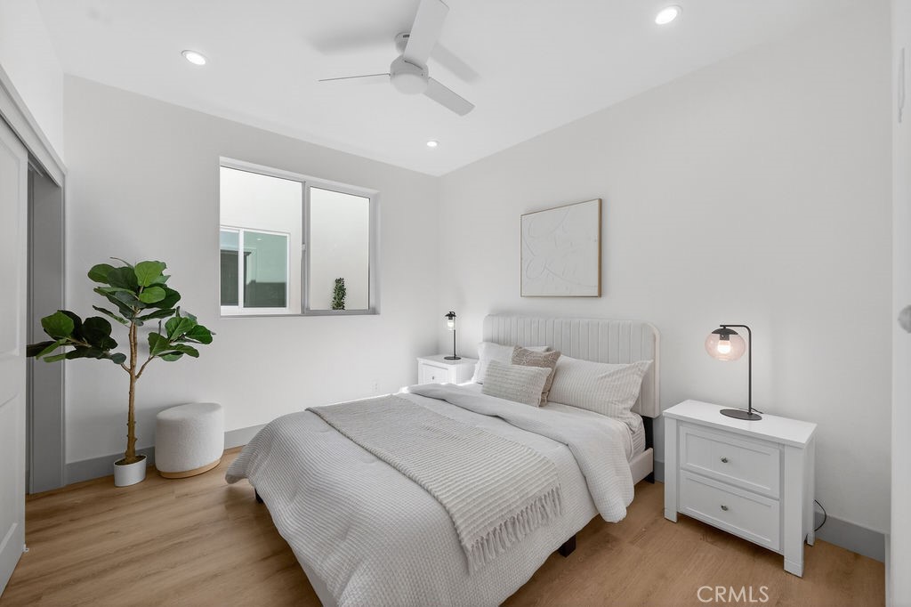15540 Colorado Avenue Paramount, CA 90723 - Photo 22 of 63 a bedroom with a bed and a potted plant