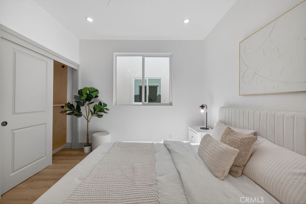 15540 Colorado Avenue Paramount, CA 90723 - Photo 23 of 63 a bedroom with a bed and a potted plant