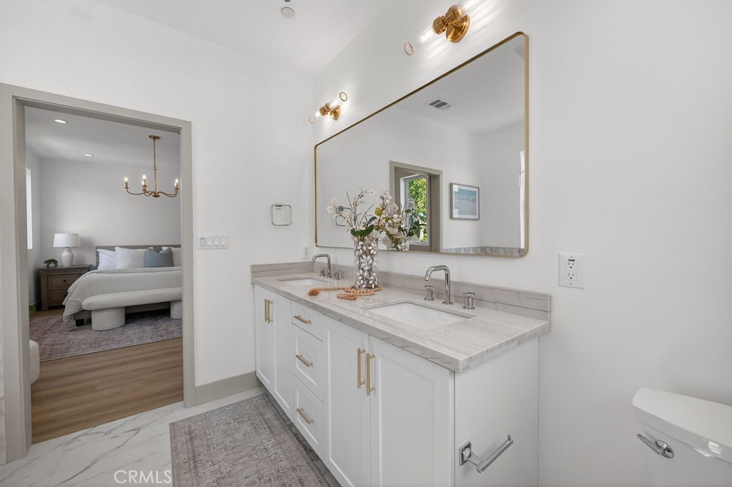 15540 Colorado Avenue Paramount, CA 90723 - Photo 39 of 63 a en suite bathroom with a sink and a mirror