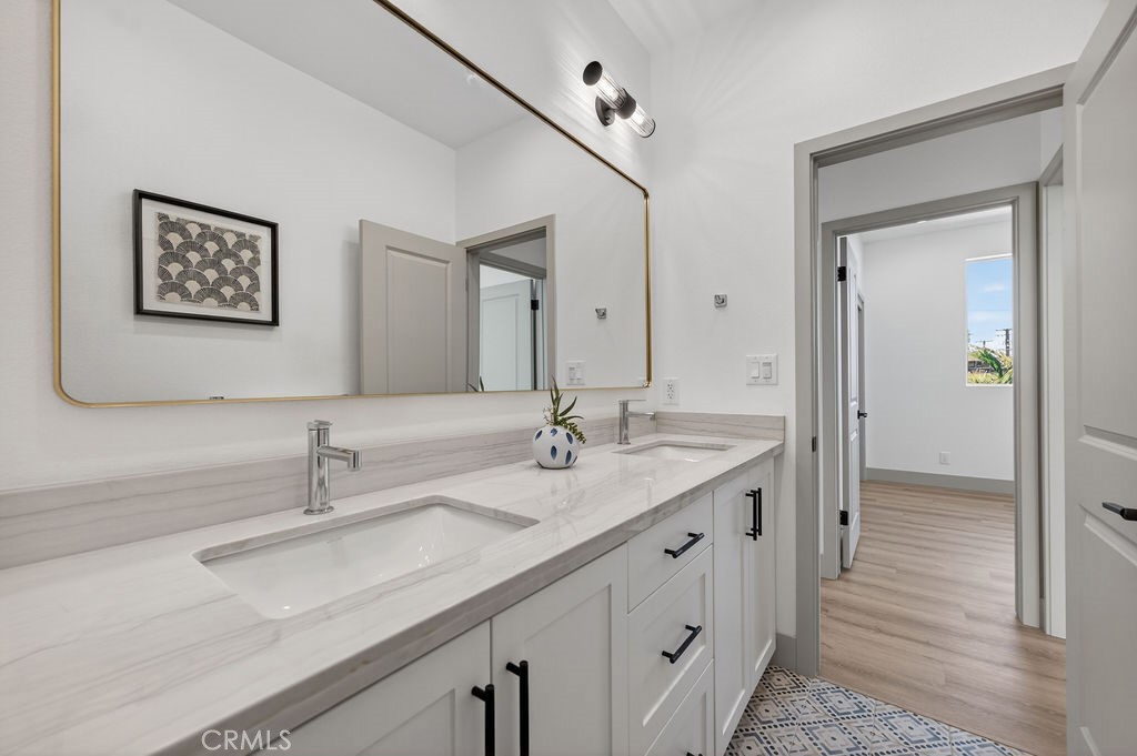 15540 Colorado Avenue Paramount, CA 90723 - Photo 46 of 63 a bathroom with double vanity sinks and a mirror
