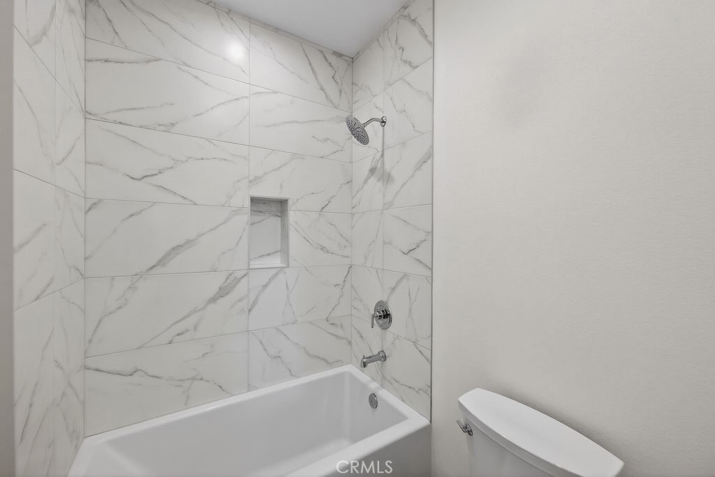 15540 Colorado Avenue Paramount, CA 90723 - Photo 48 of 63 a bathroom with a bathtub and toilet