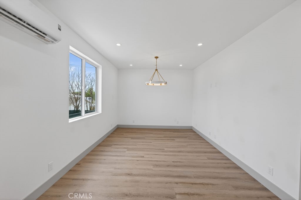 15540 Colorado Avenue Paramount, CA 90723 - Photo 57 of 63 a view of an empty room with wooden floor and a window