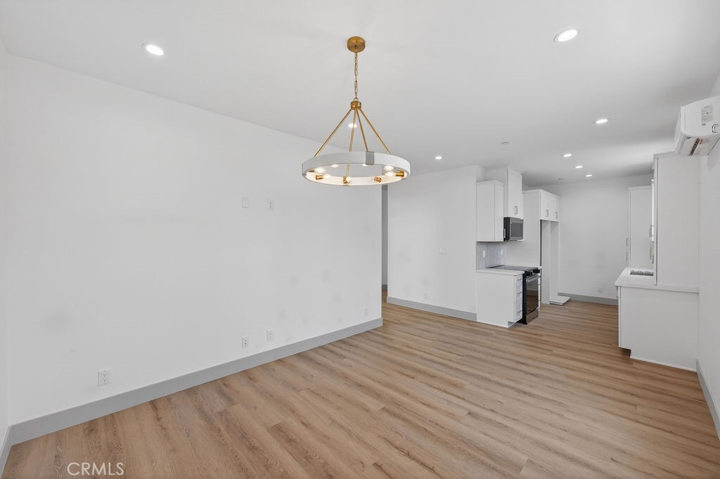 15540 Colorado Avenue Paramount, CA 90723 - Photo 59 of 63 a view of a room with wooden floor kitchen and a window