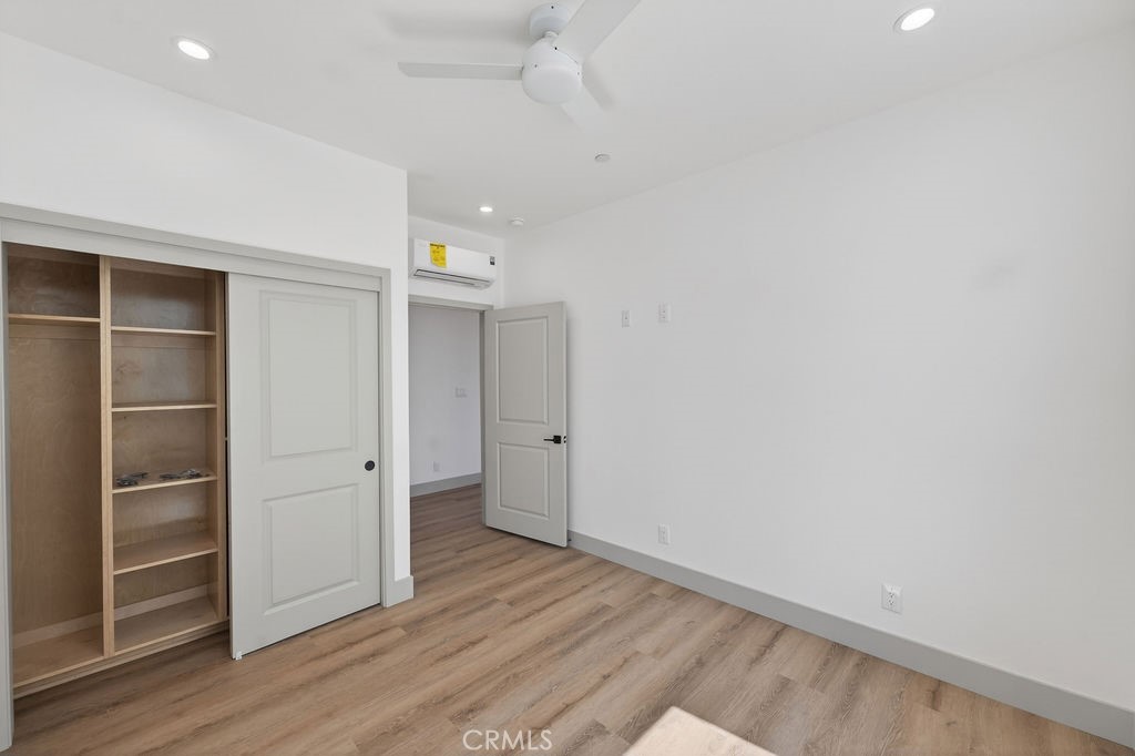15540 Colorado Avenue Paramount, CA 90723 - Photo 61 of 63 a view of an empty room with wooden floor and closet
