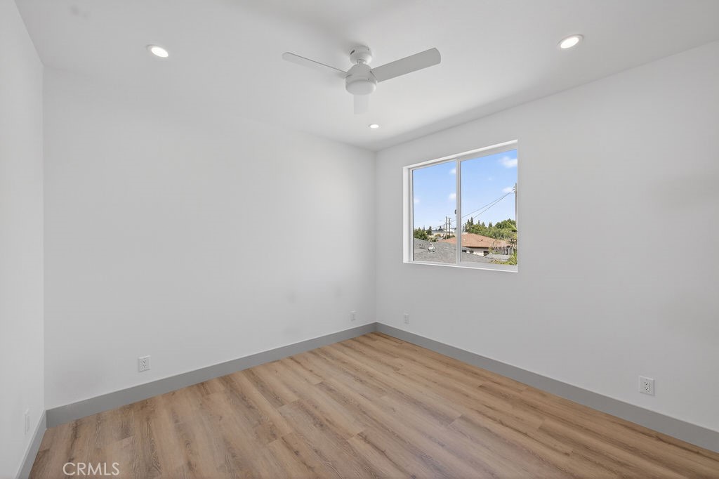 15540 Colorado Avenue Paramount, CA 90723 - Photo 62 of 63 wooden floor in an empty room with a window