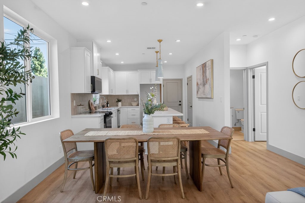 15540 Colorado Avenue Paramount, CA 90723 - Photo 8 of 63 a view of a dining room with furniture and wooden floor