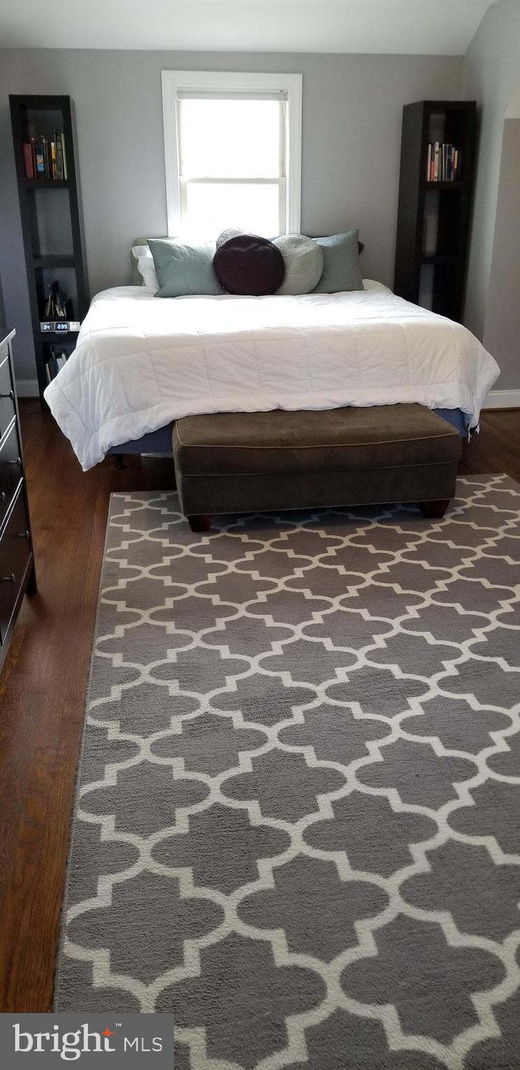 1709 Forest Glen Road Silver Spring, MD 20910 - Photo 14 of 61 a bedroom with a bed and a lamp on dresser