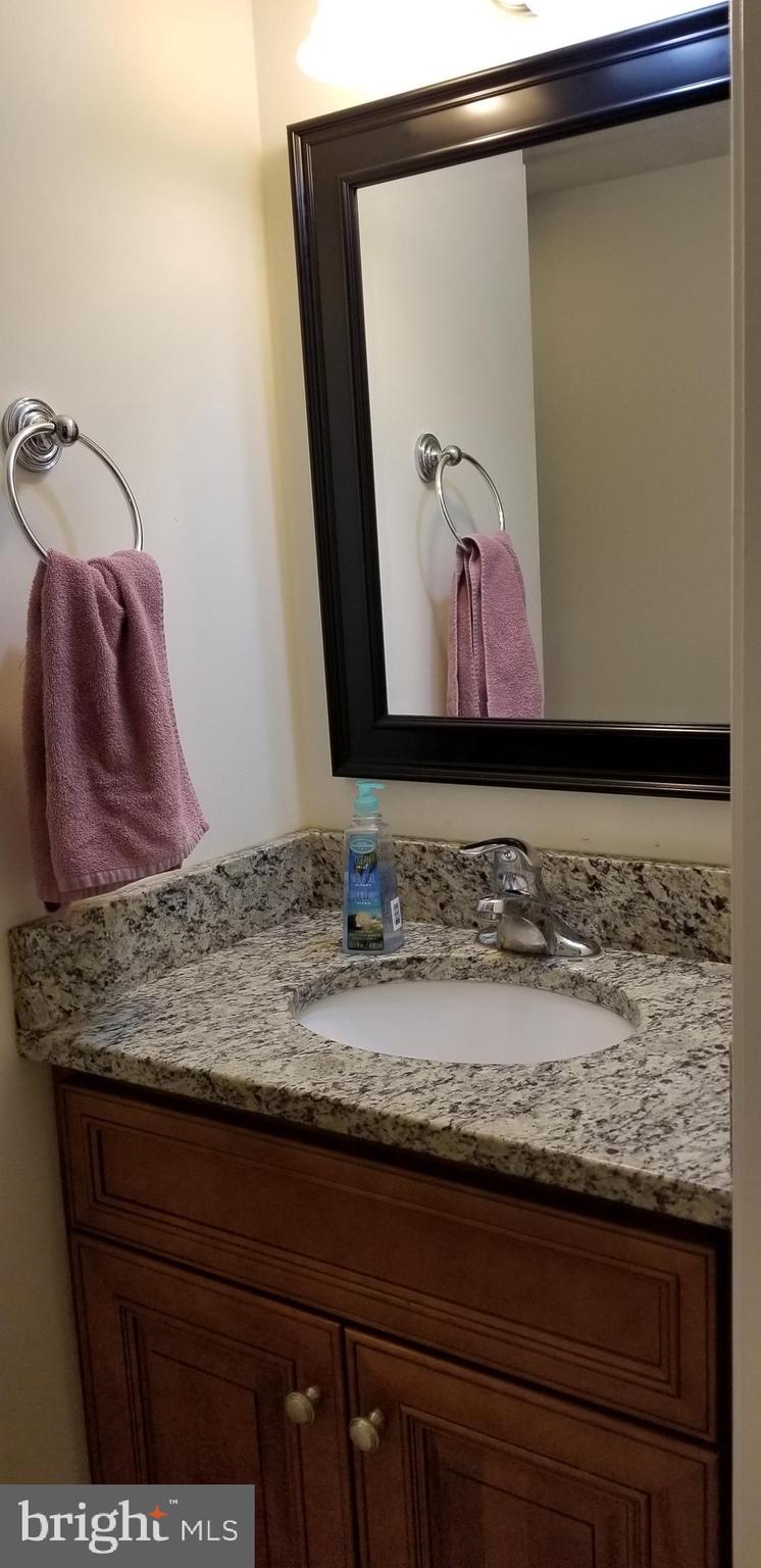 1709 Forest Glen Road Silver Spring, MD 20910 - Photo 2 of 61 a bathroom with a granite countertop sink and a mirror