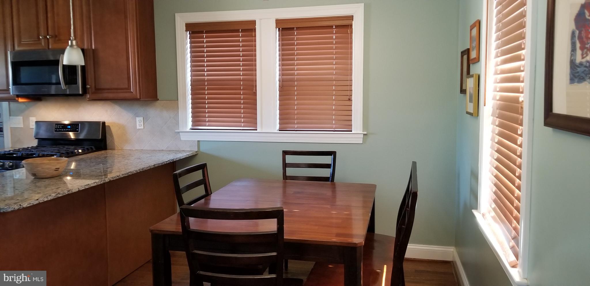 1709 Forest Glen Road Silver Spring, MD 20910 - Photo 49 of 61 a kitchen with a table chairs and a window