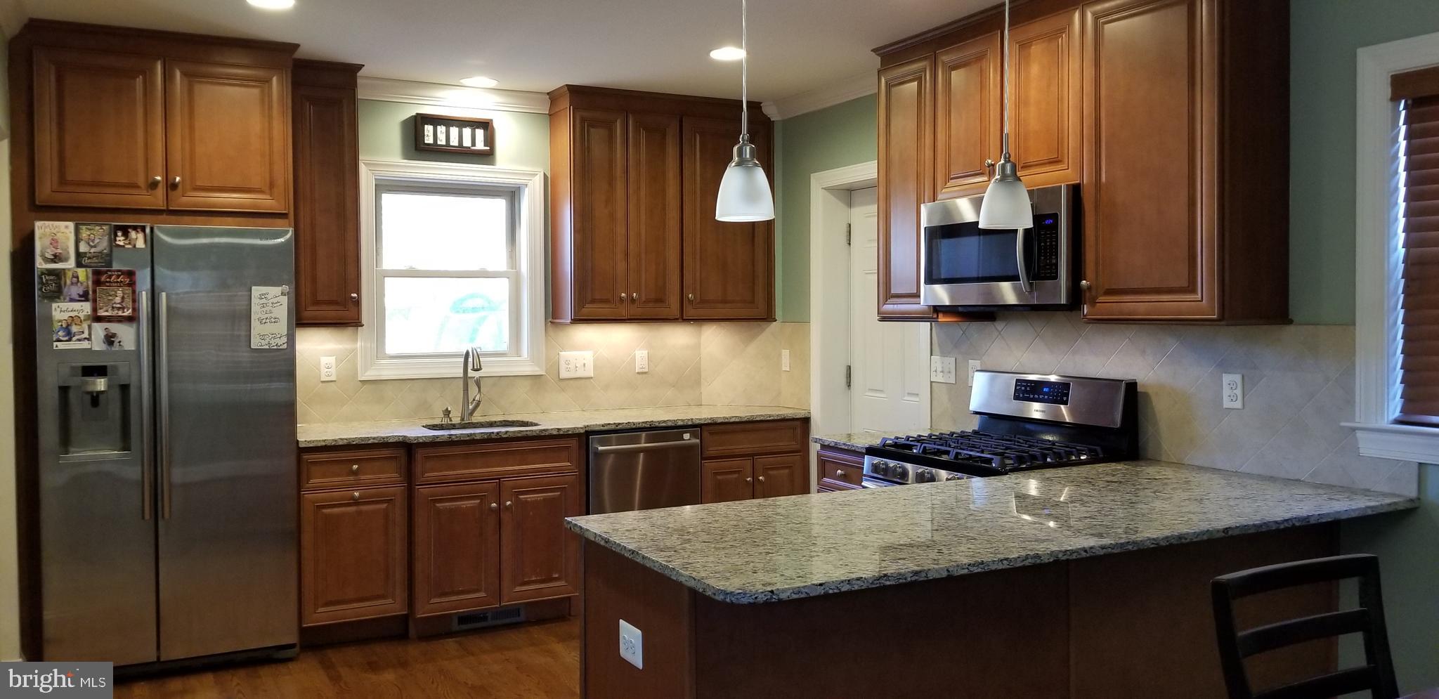 1709 Forest Glen Road Silver Spring, MD 20910 - Photo 50 of 61 a kitchen with stainless steel appliances granite countertop a sink stove and refrigerator