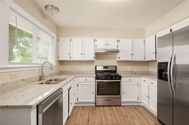 a kitchen with a sink stove and refrigerator