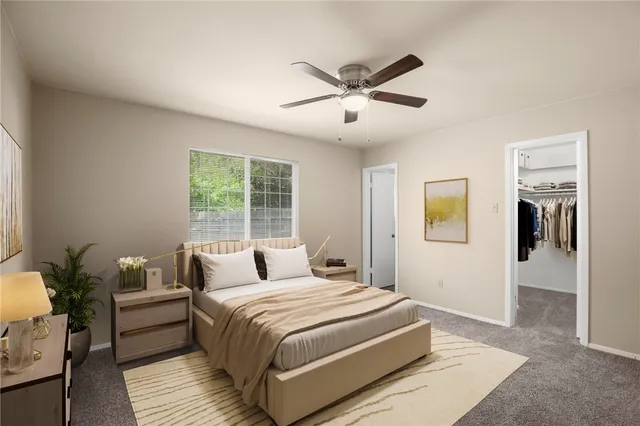 a bedroom with a large bed and a window