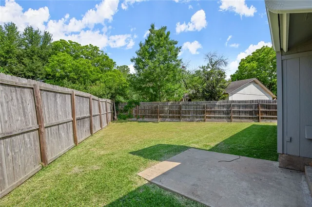 a view of yard with swimming pool and green space
