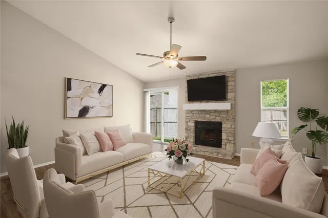 a living room with furniture a fireplace and a flat screen tv