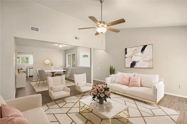 a living room with furniture and a chandelier