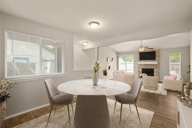 a dining room with furniture window and wooden floor