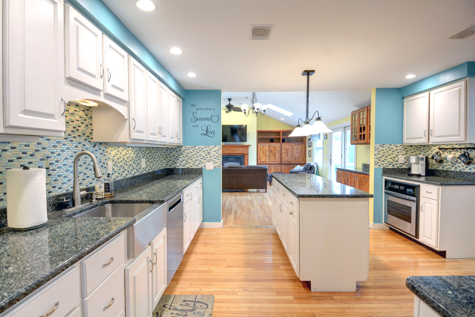 35 Mariners Way Edgartown, MA 02539 - Photo 13 of 32 a kitchen with stainless steel appliances granite countertop wooden cabinets a sink dishwasher a stove and a kitchen island with wooden floor