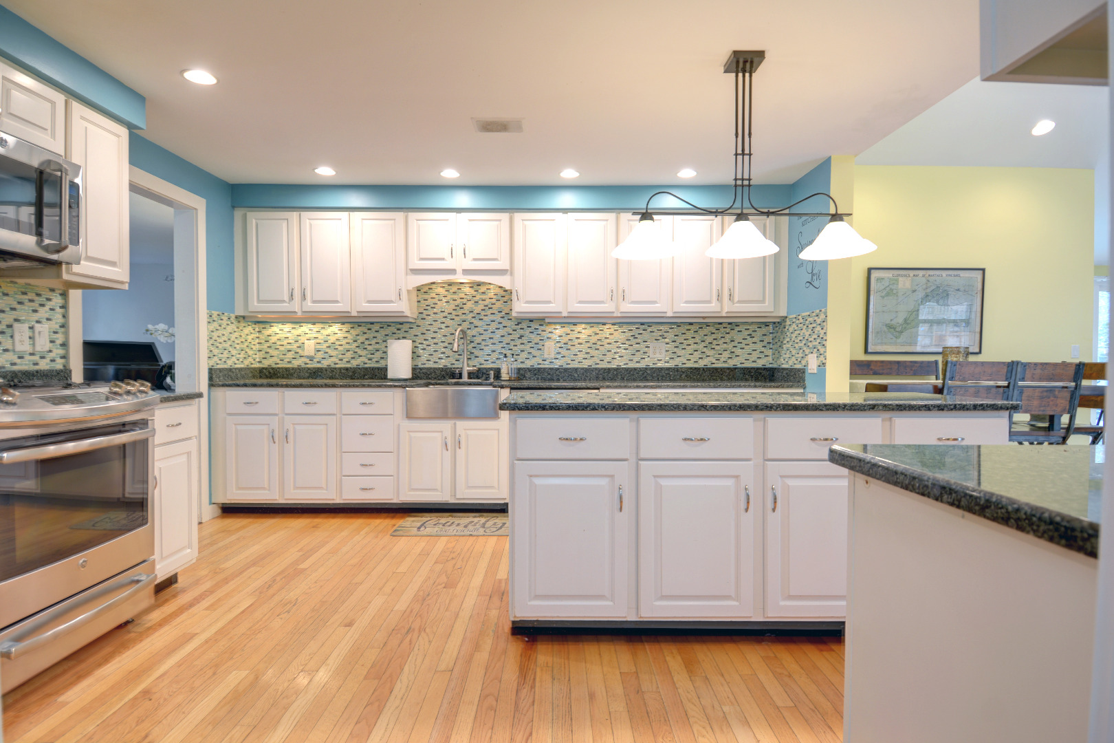 35 Mariners Way Edgartown, MA 02539 - Photo 14 of 32 a kitchen with stainless steel appliances granite countertop wooden cabinets and a wooden floor
