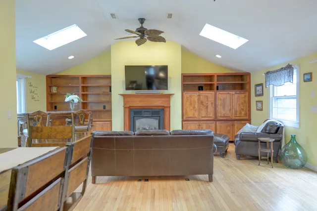 a living room with stainless steel appliances kitchen island granite countertop furniture and a fireplace