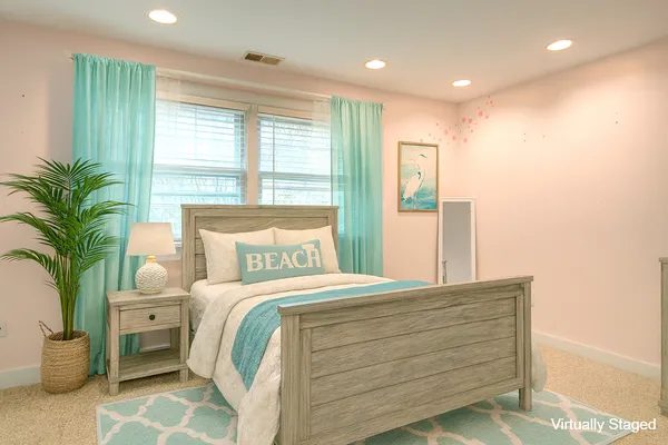 a bedroom with a large bed and a potted plant