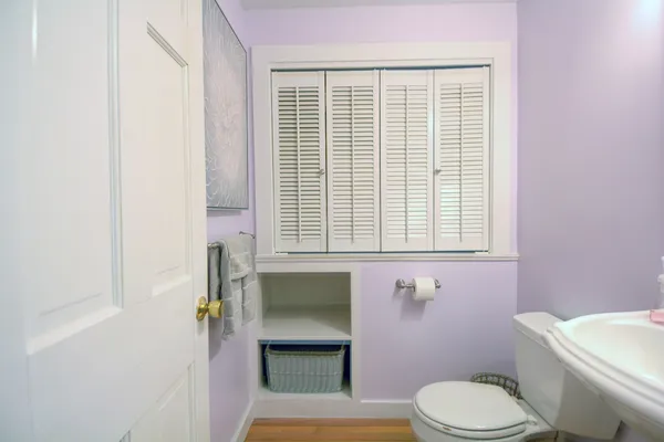 a bathroom with a toilet a sink and a window