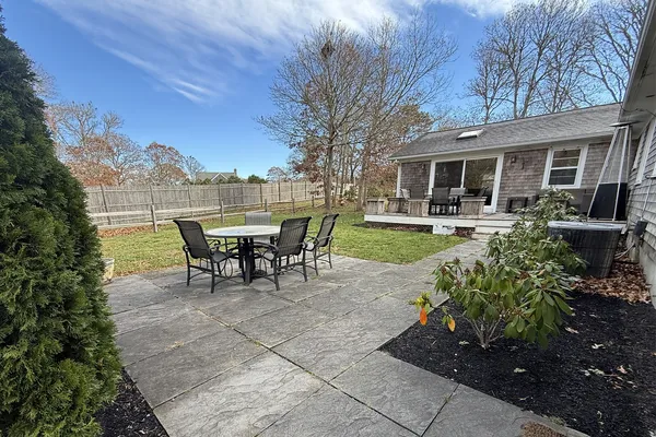 a view of a house with backyard and sitting area