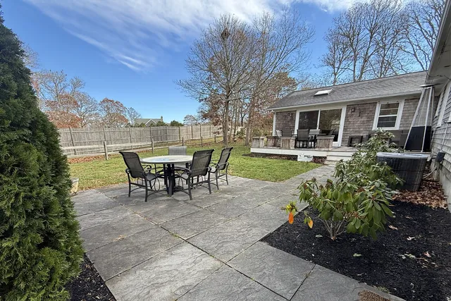 a view of a house with backyard and sitting area