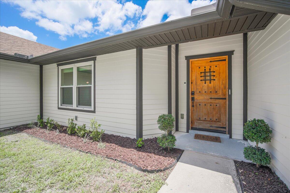 3500 Weber Road Malabar, FL 32950 - Photo 7 of 45 a front view of a house with garden