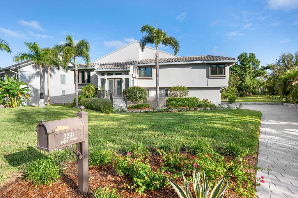 3210 Bayou Sound Longboat Key, FL 34228 - Photo 1 of 58 a front view of house with yard and green space
