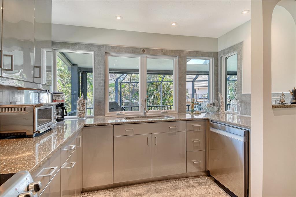 3210 Bayou Sound Longboat Key, FL 34228 - Photo 12 of 58 a large kitchen with a sink and cabinets