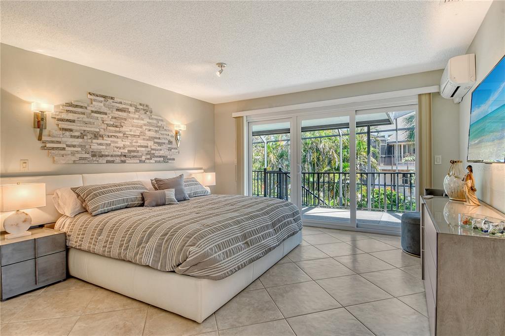 3210 Bayou Sound Longboat Key, FL 34228 - Photo 13 of 58 a bedroom with a large bed and a large window