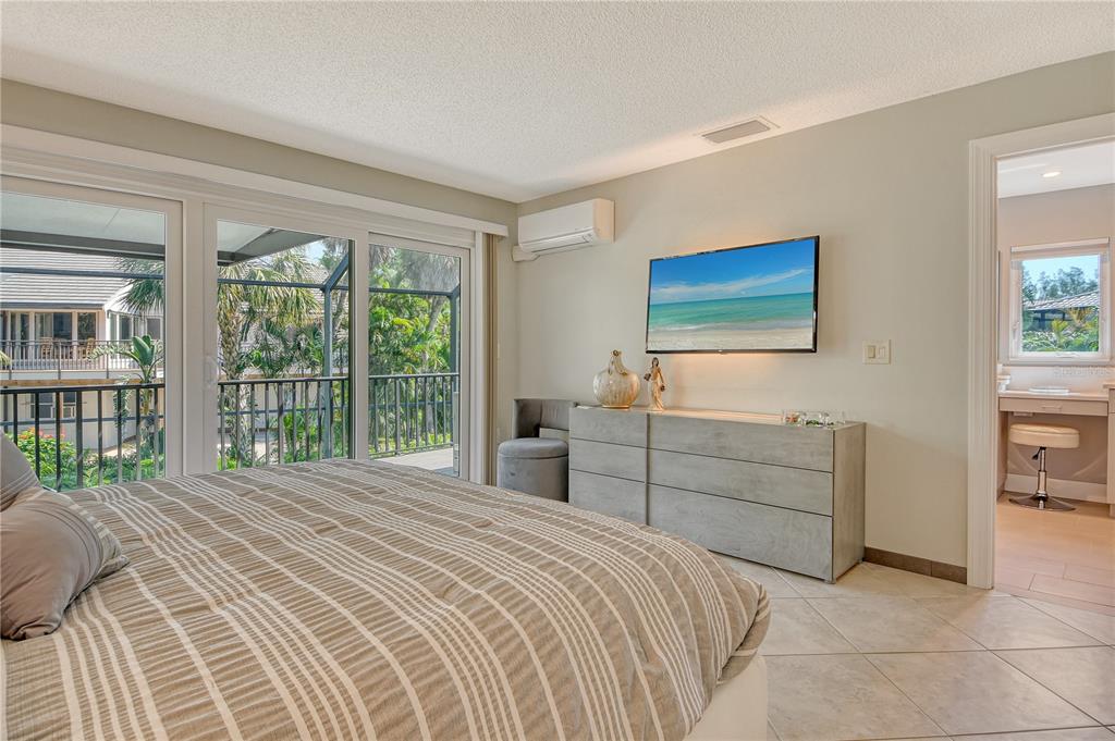 3210 Bayou Sound Longboat Key, FL 34228 - Photo 14 of 58 a bedroom with a bed and a large window