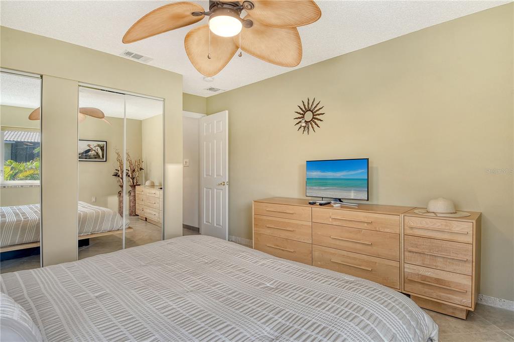 3210 Bayou Sound Longboat Key, FL 34228 - Photo 19 of 58 a bedroom with a bed and a chandelier