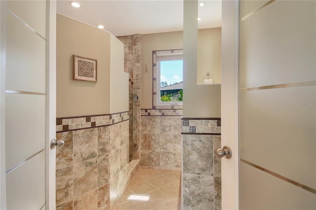 3210 Bayou Sound Longboat Key, FL 34228 - Photo 20 of 58 a bathroom with a bathtub and shower