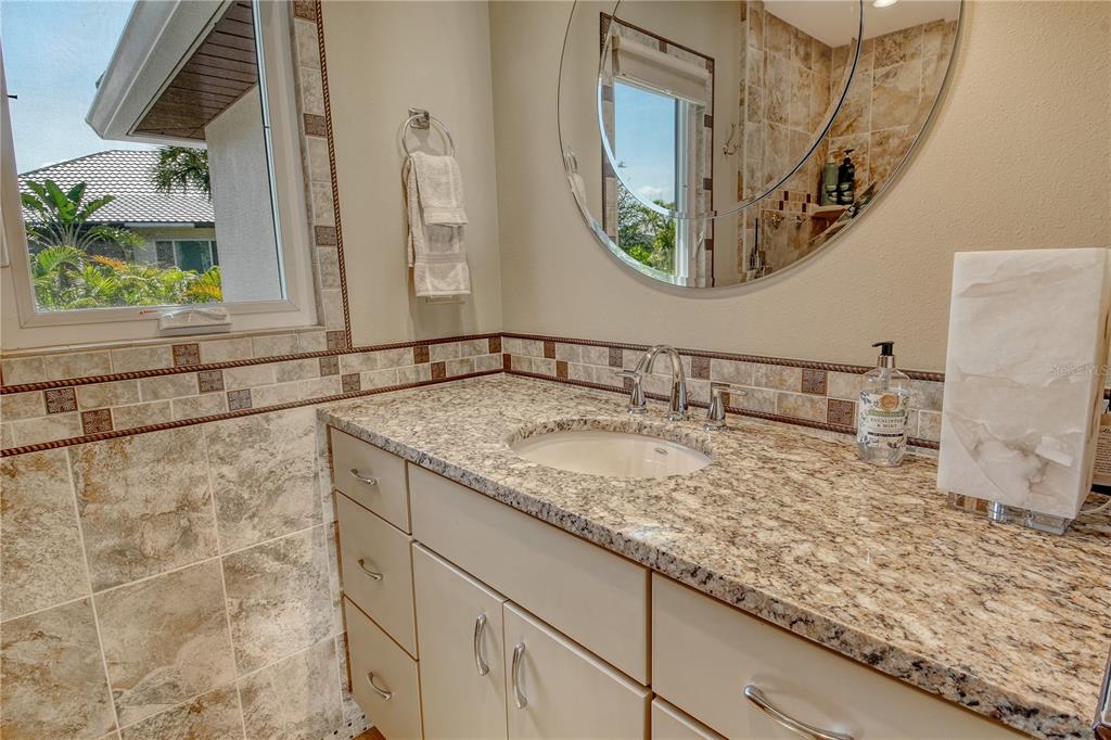 3210 Bayou Sound Longboat Key, FL 34228 - Photo 22 of 58 a bathroom with a granite countertop sink and a mirror