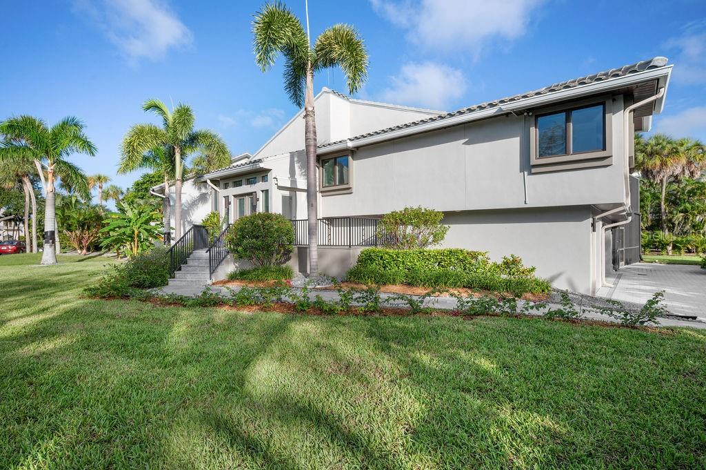 3210 Bayou Sound Longboat Key, FL 34228 - Photo 4 of 58 a front view of a house with garden