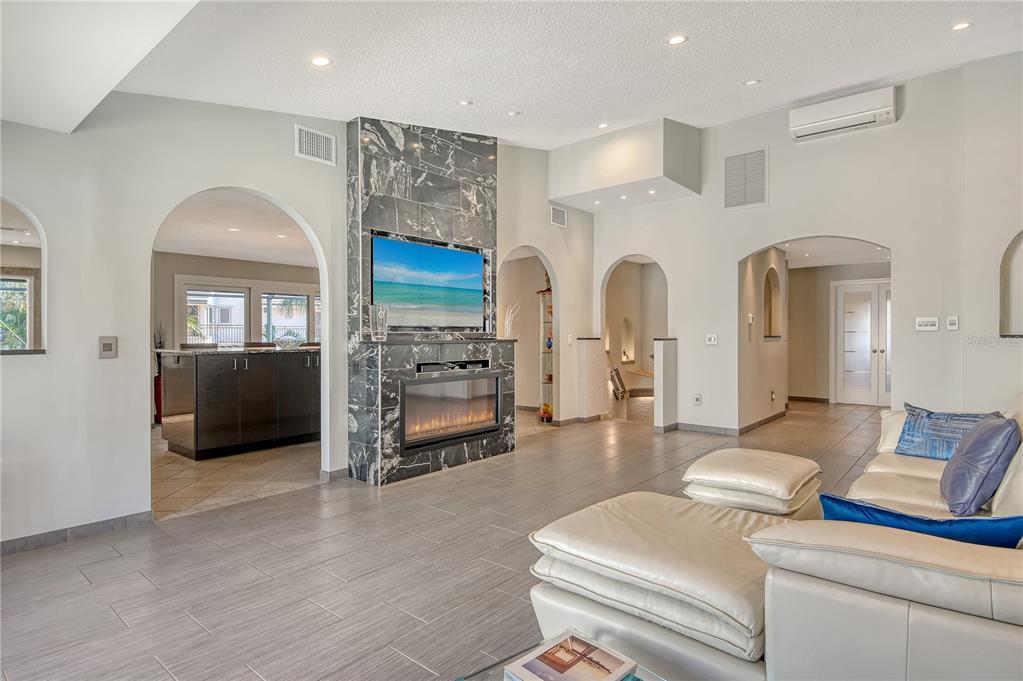 3210 Bayou Sound Longboat Key, FL 34228 - Photo 8 of 58 a living room with furniture and a fireplace
