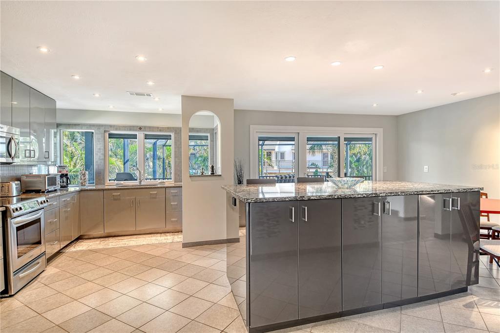 3210 Bayou Sound Longboat Key, FL 34228 - Photo 9 of 58 a kitchen with stainless steel appliances granite countertop a refrigerator and a sink