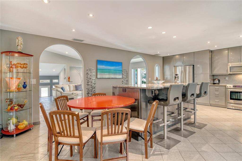 3210 Bayou Sound Longboat Key, FL 34228 - Photo 10 of 58 a dining room with a table and chairs