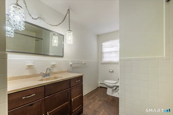 a bathroom with a sink a toilet and a mirror
