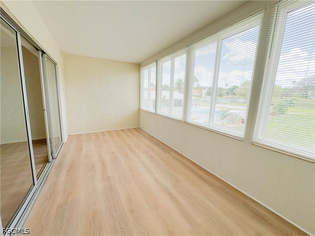 1830 Brantley Road, Unit I7 Fort Myers, FL 33907 - Photo 29 of 34 a view of an empty room with wooden floor and a window