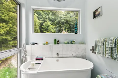a bathroom with bathtub and window