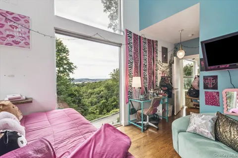 a bedroom with a bed and a flat tv screen on dresser
