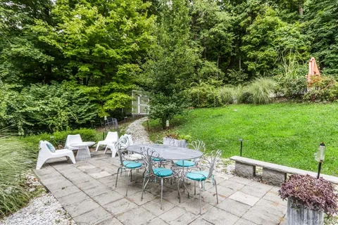 a view of a chairs and table in backyard of the house
