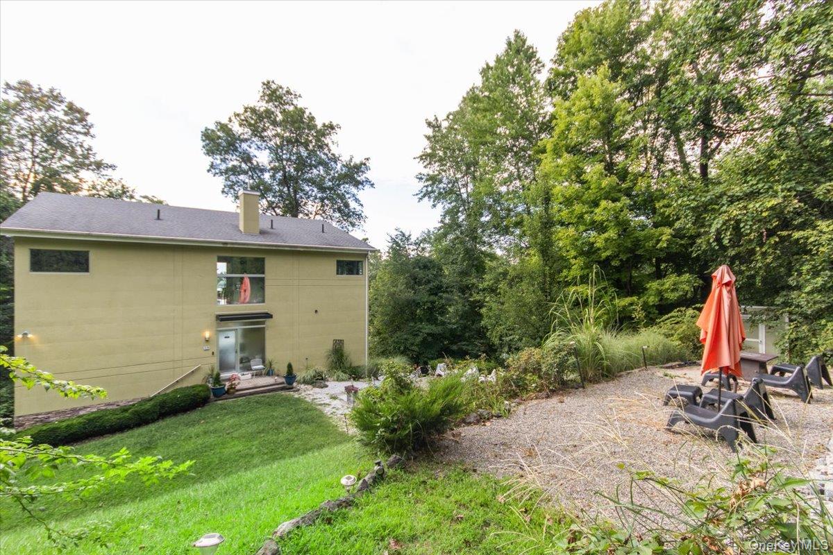 19 Melzingah Reservoir Road Beacon, NY 12508 - Photo 19 of 34 a backyard of a house with table and chairs